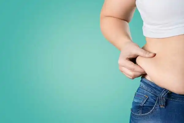 Image of woman pinching her love handles to show weight gain Sandwich